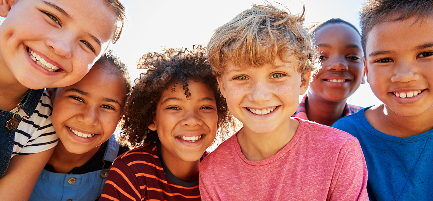 Children gathered in a group smiling